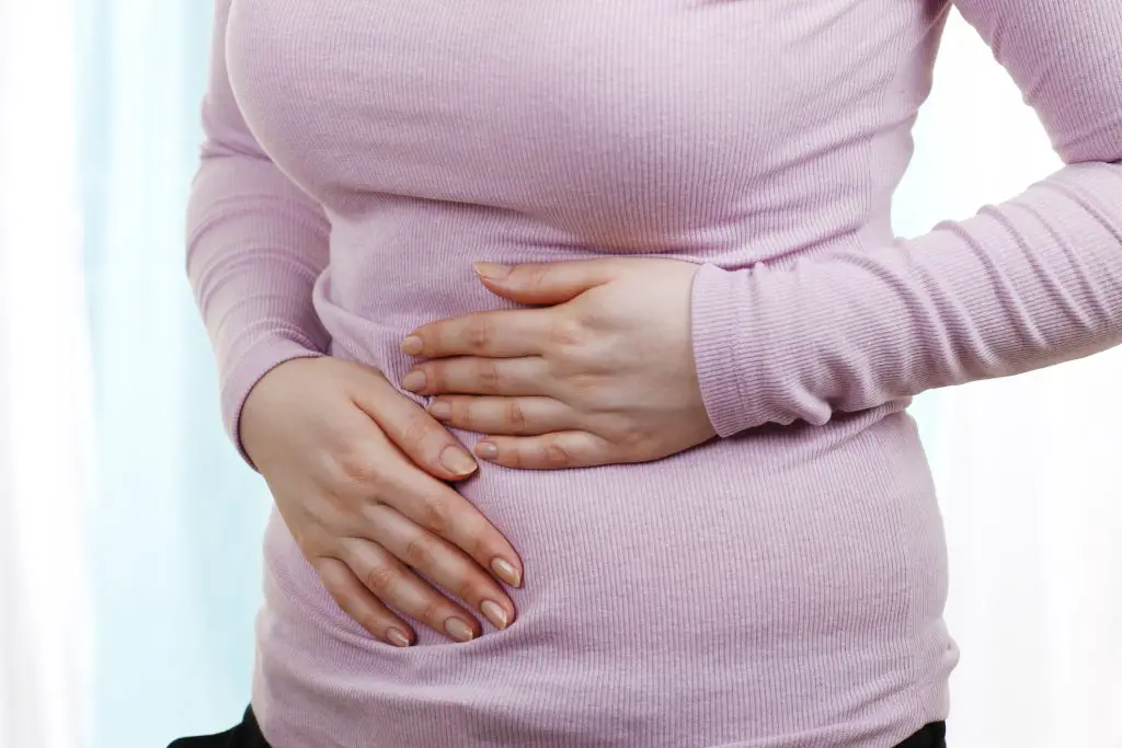 Woman with stomach pains - probiotics for women's health