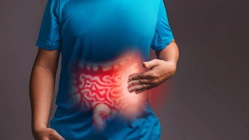 Man holding his stomach in pain., Irritable Bowel Syndrome IBS explained