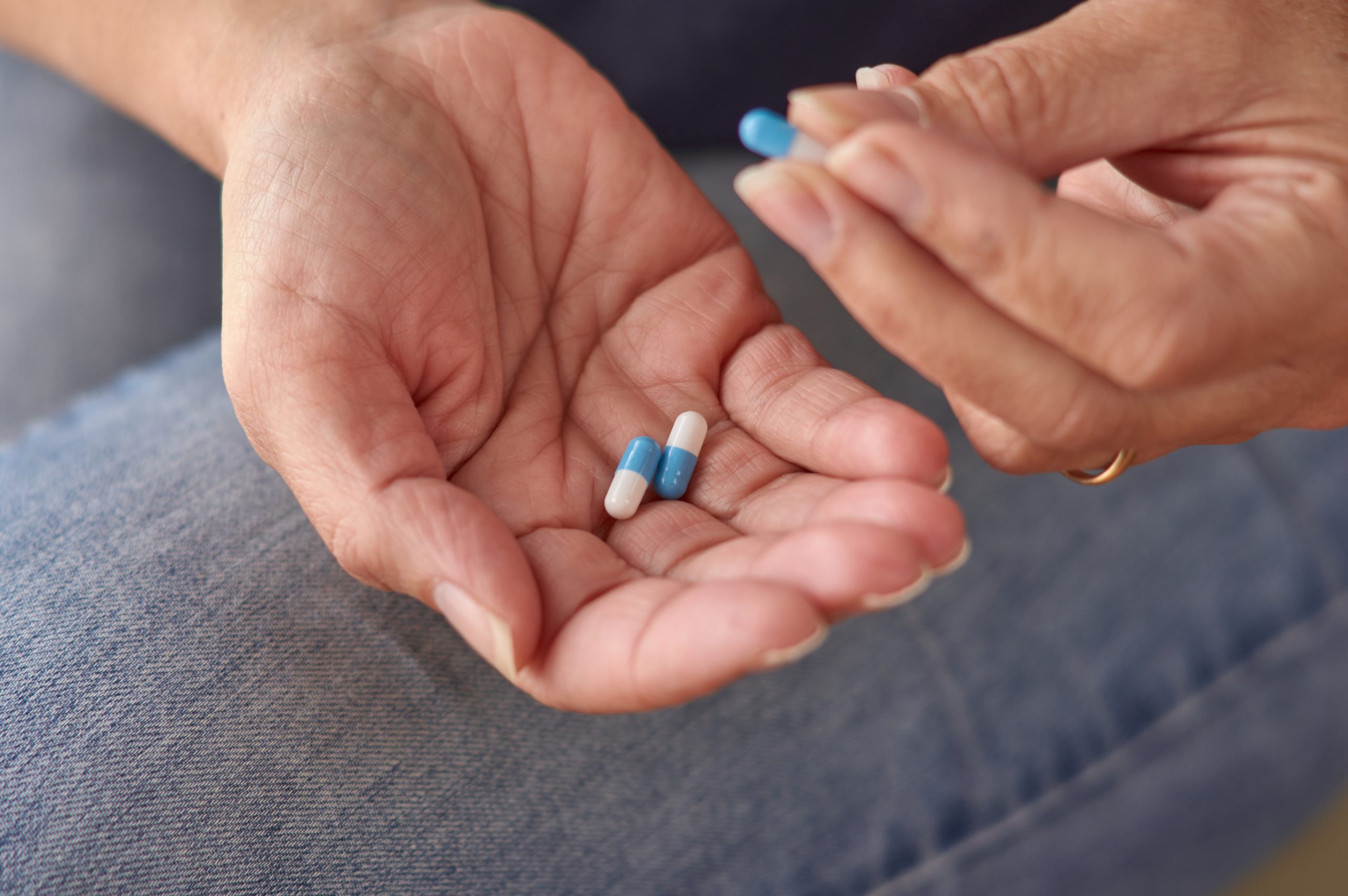 Woman taking a probiotic capsule once a day